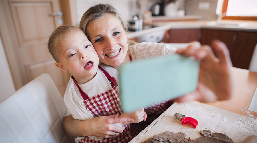 A mother and son baking and taking a photo together